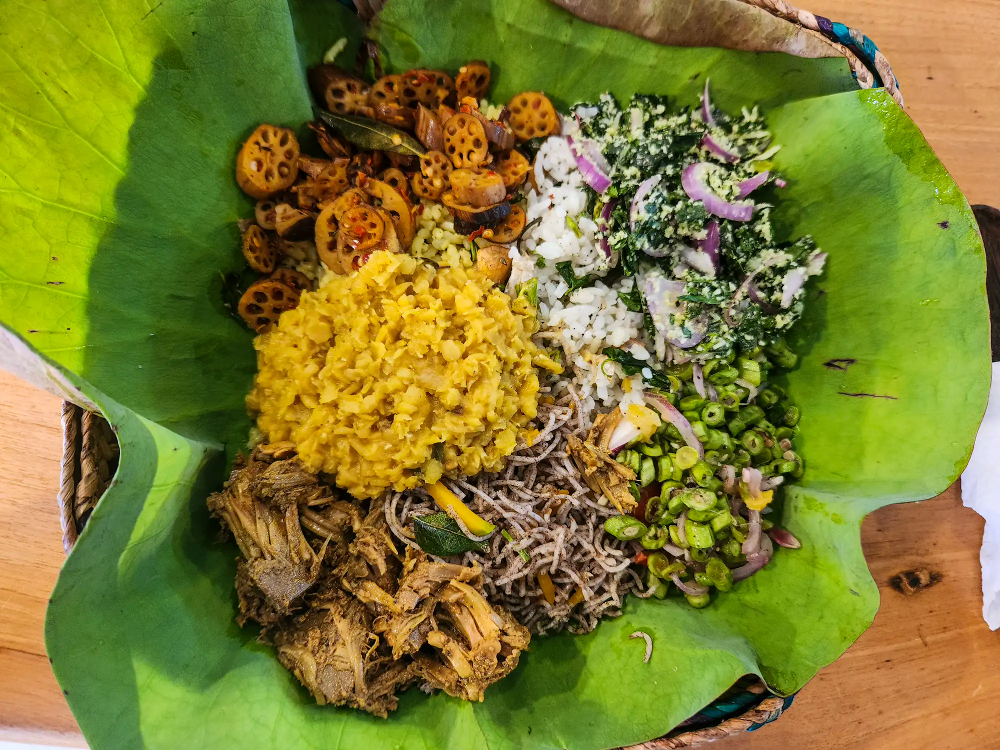 Rice and curry served on a banana leaf: dhal, mallum, fried aubergine, pickled onions and jackfruit